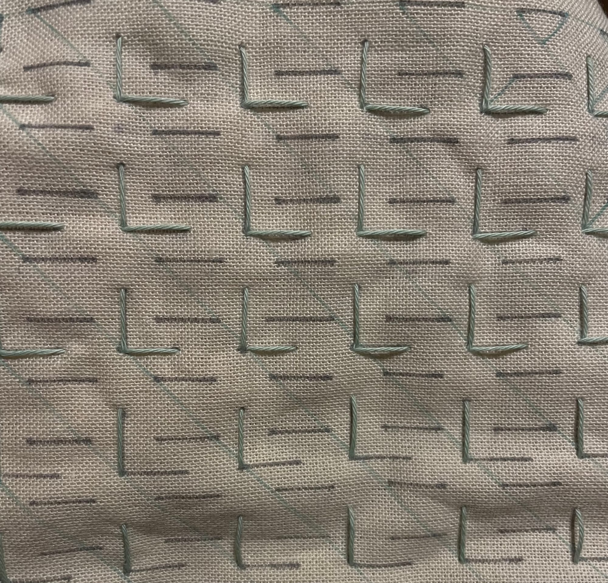 Horizontal lines of the tulip pattern stitched in light green