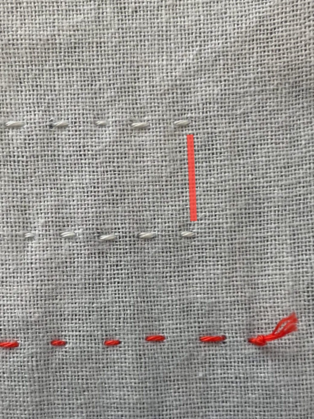 The wrong side of fabric with sashiko stitches to illustrate where thread is carried