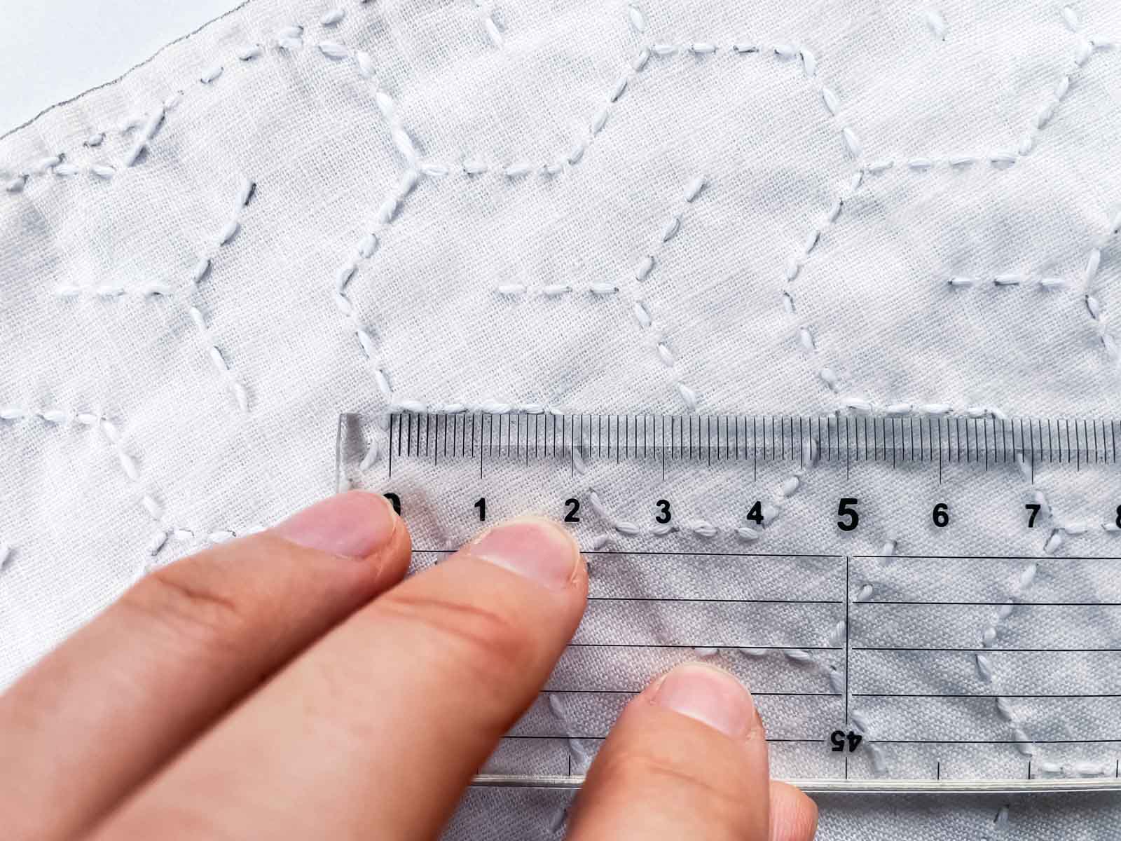 Sashiko cloth with ruler laid on top to measure stitch length.