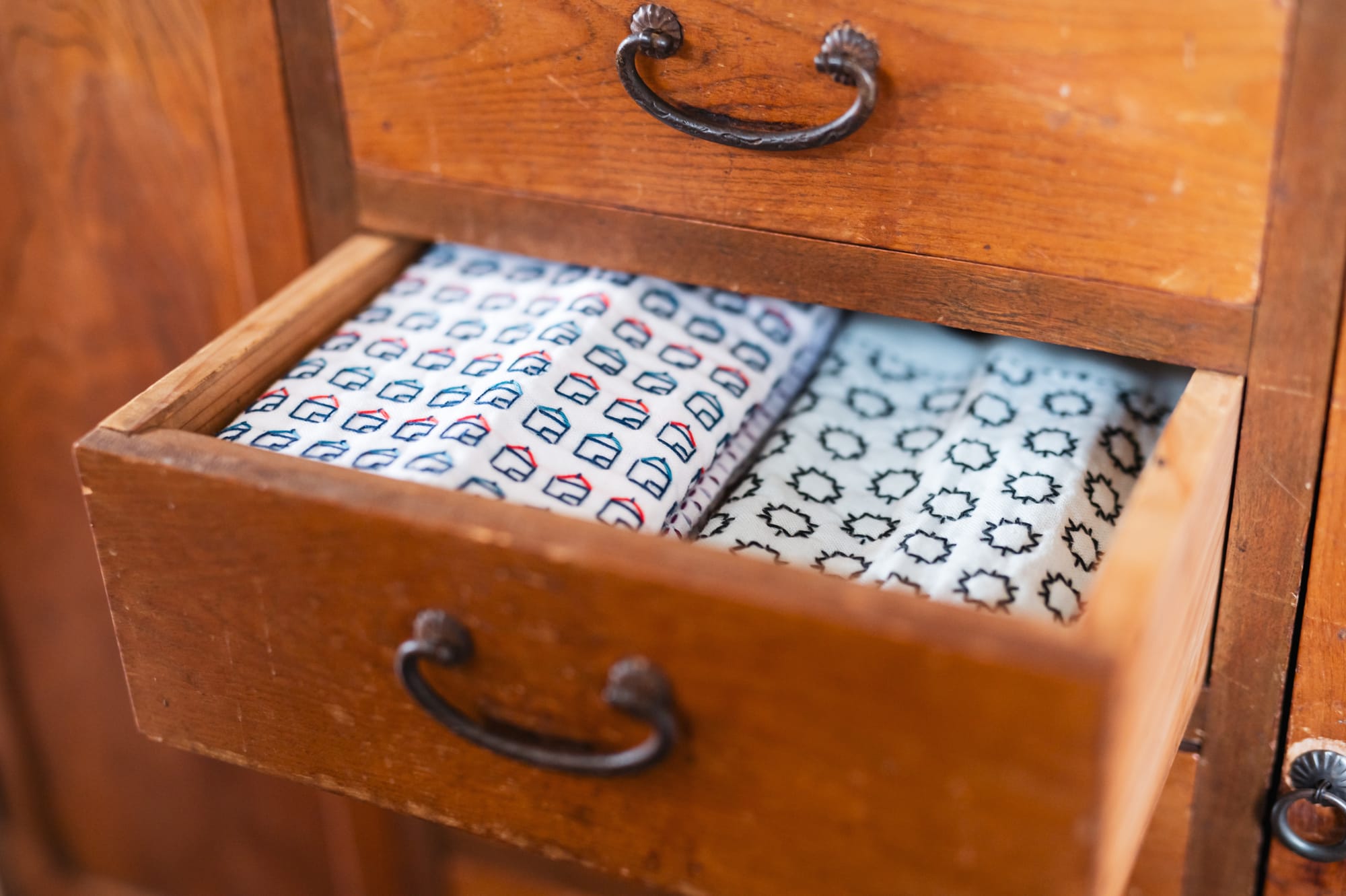 Sashiko kitchen cloths peeking out of a drawer.