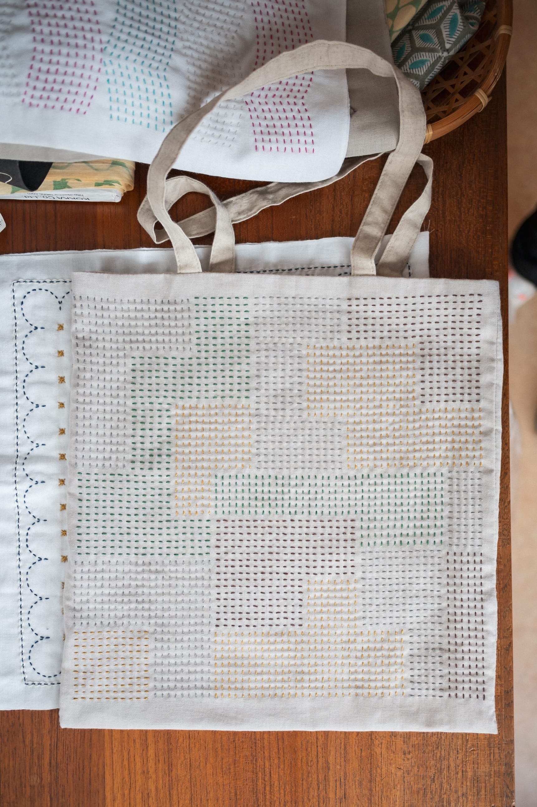 A tote bag with a modern sashiko pattern in various colors on a cupboard.